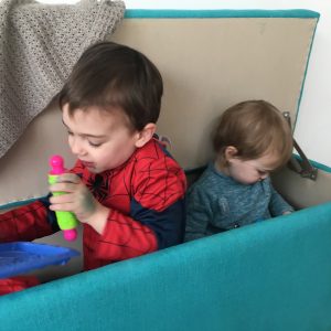 children in a box pretending to be an aeroplane