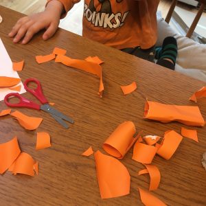 child's creation made from cut up orange paper
